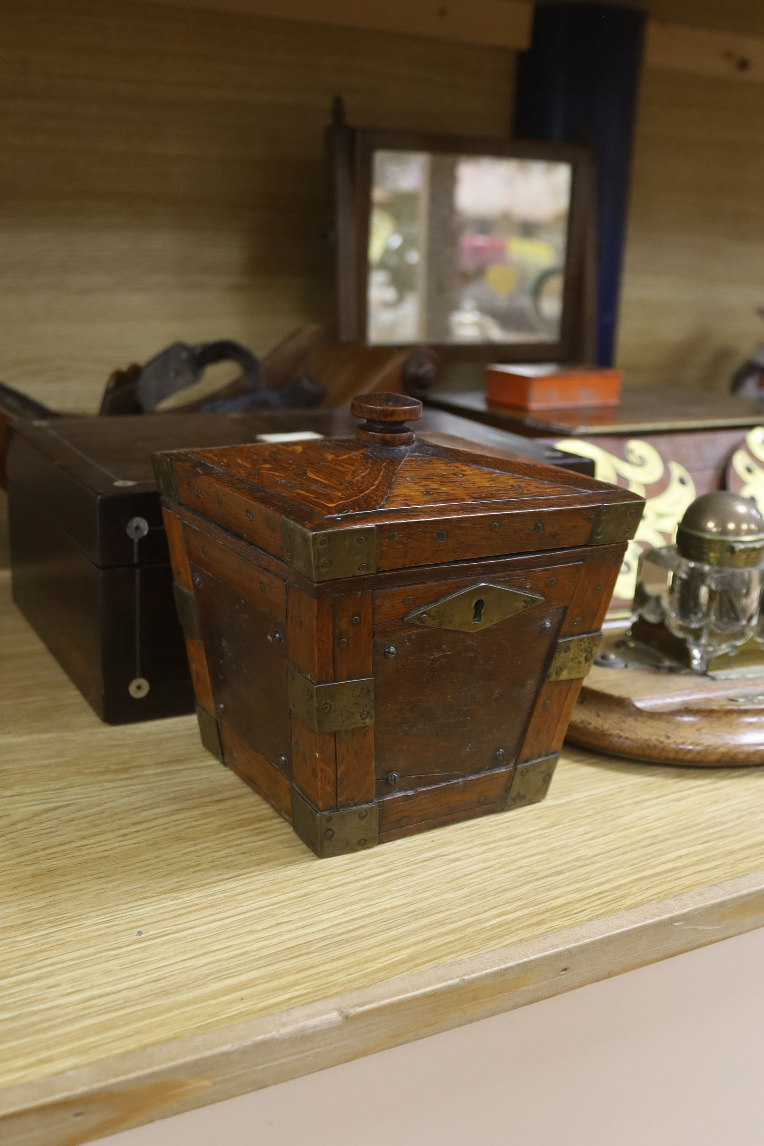 A Victorian mahogany cheese coaster, 40cm, an early 19th century toilet mirror, 29cm, an oak tea caddy, a book slide, an ink stand and sundry boxes
